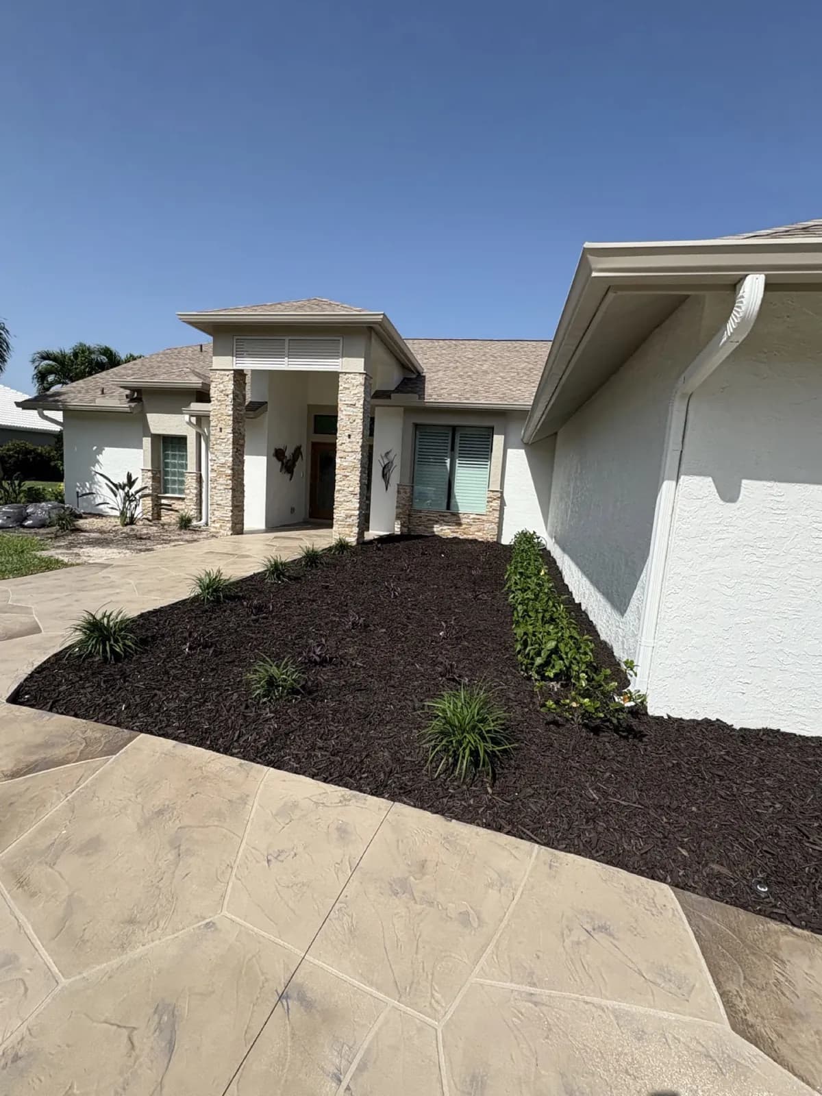 Fresh mulch bed stone facade front entry, Cape Coral, Florida, by Blue Collar Q