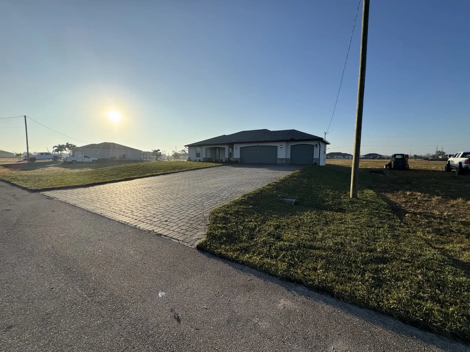 Wide paver driveway and new sod at a newly built home in Cape Coral